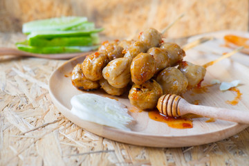 Roasted pork balls or meatballs with sweet spicy sauce, selectiv