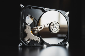 Disassembled hard drive from the computer, hdd with mirror effect. Opened hard drive from the computer hdd with mirror effects. Part of computer pc, laptop
