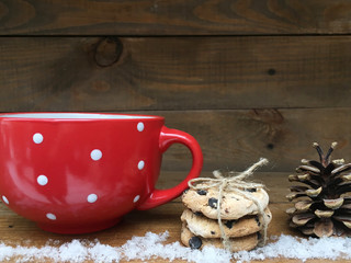New year red cup with white dots. Christmas sweets. Wooden date 2017
