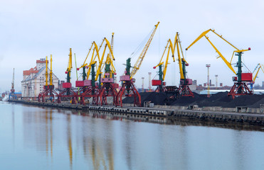 Fototapeta premium Port cranes. Port terminal logistics. Freight cars to the river or sea port. Kaliningrad, Russia