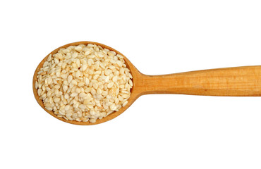 Sesame seeds on wooden spoon isolated on white background