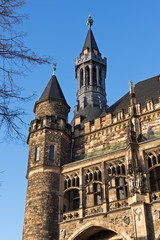 Fototapeta premium Part of the Aachen City Hall with towers and figures against the blue sky