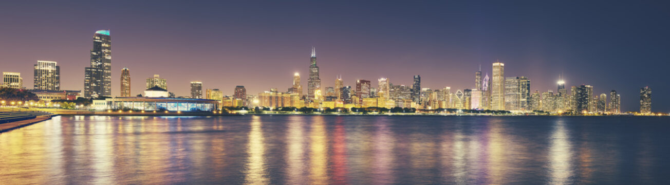 Retro toned panoramic picture of Chicago city skyline at night, USA.