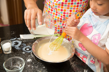 Asian family enjoy making pancake, Asian mother teaching daughter to make bakery