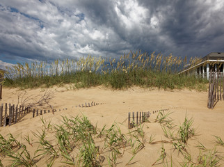 North Carolina Outer Banks sand dunes under dramatic lighting. Horizontal.