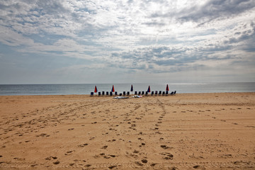 Sky, ocean, beach, and empty chairs. Outer Banks, North Carolina. Horizontal.