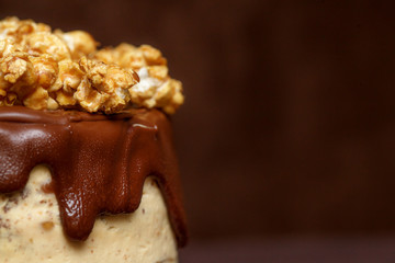 Chocolate cake with caramel and popcorn, close up