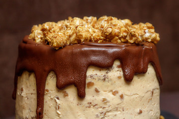 Chocolate cake with caramel and popcorn, close up