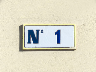 Street sign reading the number one.