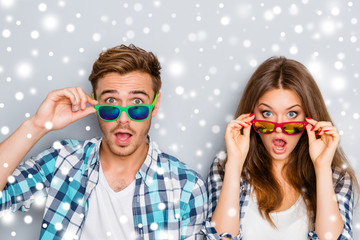 Surprised man and woman in glasses with open mouth on the backgr