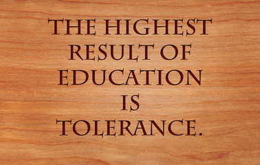The highest result of education is tolerance - quote by Helen Keller on wooden red oak background