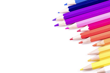 Abstract angle of multiple coloured pencils on white, with space for text