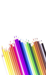 Abstract angle of jagged row of coloured pencils on white, with space for text
