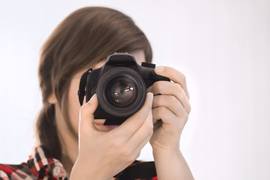 girl with camera on white background / photographer / cameraman / camerist