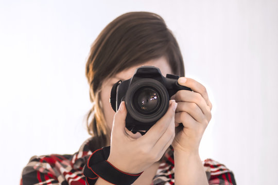 girl with camera on white background / photographer / cameraman / camerist