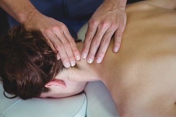 Fototapeta na wymiar Physiotherapist giving neck massage to a woman