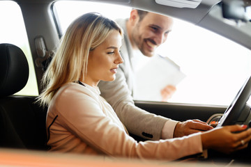 Salesperson selling cars at dealership