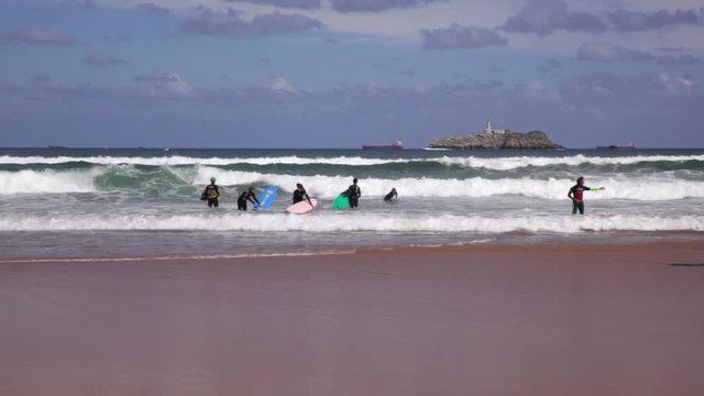 SANTANDER, SPAIN - AUGUST, 20: Boys teen surfing in Cantabrian sea on August 20, 2016