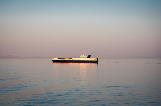 Container bulk carrier ship in a clam sea at dawn