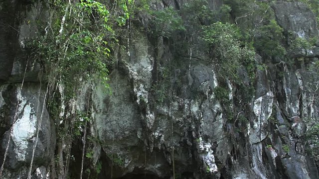 Mouth of the Underground River Cave. Floating towards the entrance to the Puerto Princesa Subterranean River National Park on the Palawan Island of the Philippines.