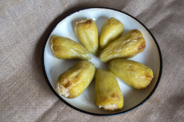 roasted peppers stuffed with rice and spices on fabric background 