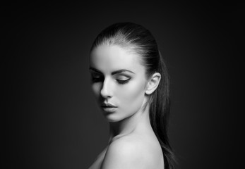 Beauty portrait of a young woman on grey