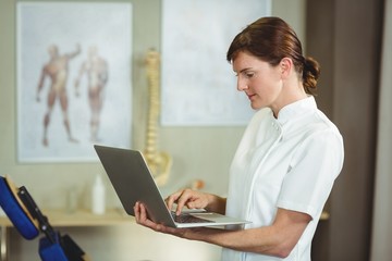 Physiotherapist using a laptop