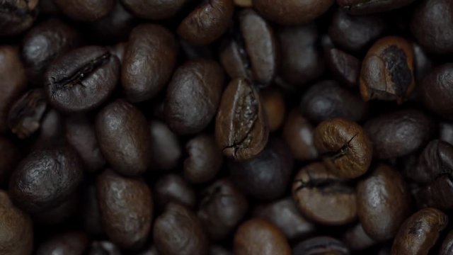 Rotating and falling Coffee beans. Slow Motion
