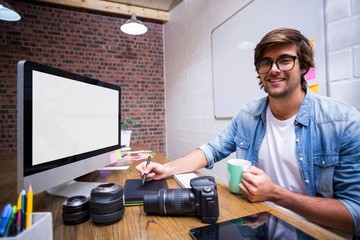 Portrait of smiling graphic designer working in office