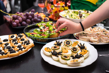 stuffed eggs and sandwiches in a plate on the table