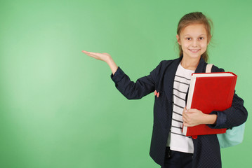 Young school girl with red book and backpack