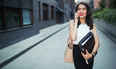 Beautiful businesswoman using phone