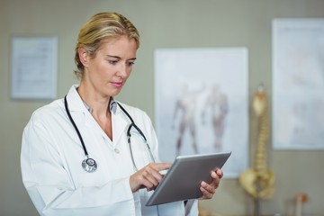 Female physiotherapist using digital tablet