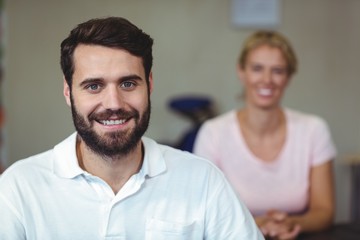 Male therapist smiling in clinic