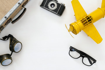 vintage yellow toy plane and old photo camera
