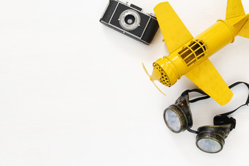 vintage toy plane, old photo camera and pilot glasses