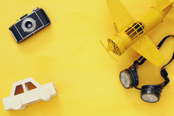  vintage toy plane, old photo camera and pilot glasses