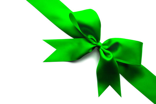 Green satin ribbon and bow isolated on white