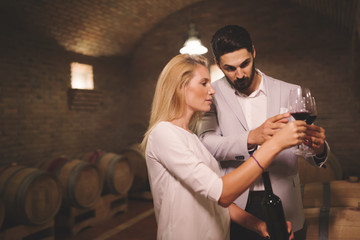 People tasting wine in winery