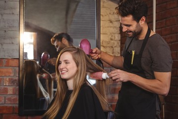 Pretty woman getting her hair dried