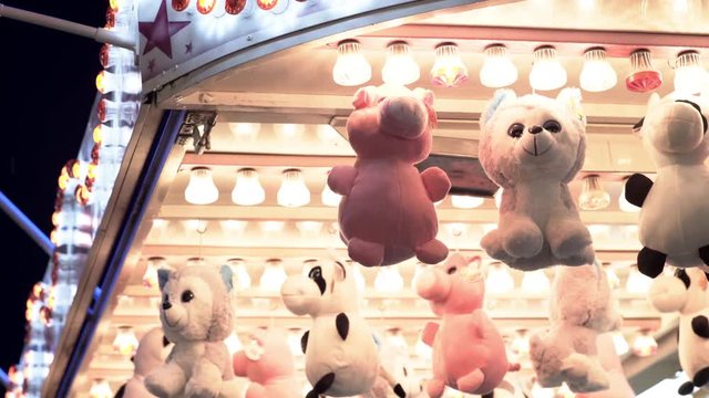 Stuffed animal prizes hanging on carnival game.