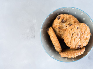 Chocolate chip cookies in bowl on gray background