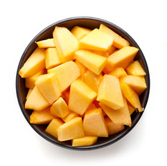 Bowl of pumpkin pieces isolated on white, from above