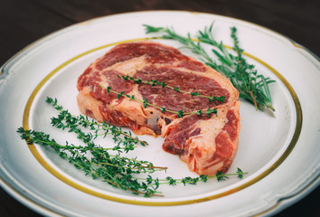 Rib eye steak in a rustic plate, toned