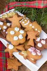 Colorful Christmas gingerbread cookies on wooden background