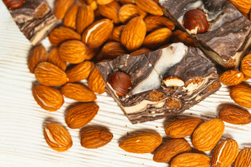 candy paste and almonds on white wooden background