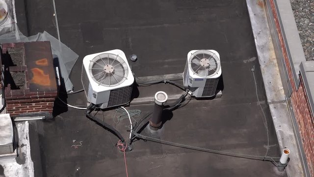 Air conditioning unit on top of industrial building to keep interior cool.