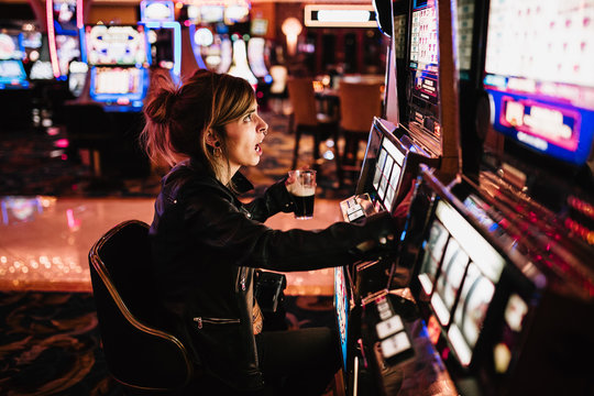 Woman playing slot machine
