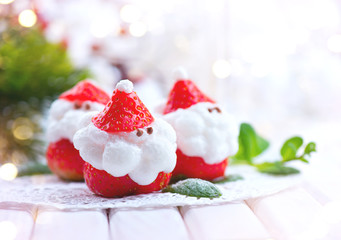 Christmas strawberry Santa. Funny dessert stuffed with whipped cream. Xmas party food idea