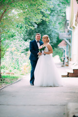 Naklejka premium bride and groom on the background of the garden fence